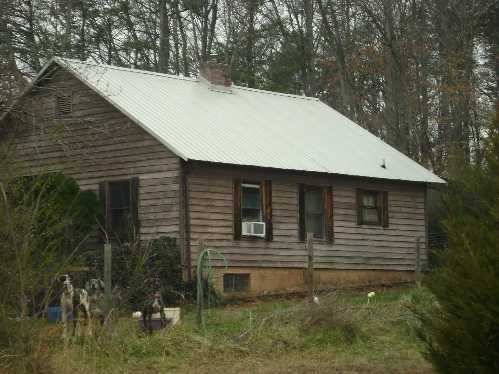 White metal roof on an old wood sided farmhouse, from a Metal Roof Installation job in Newark Valley